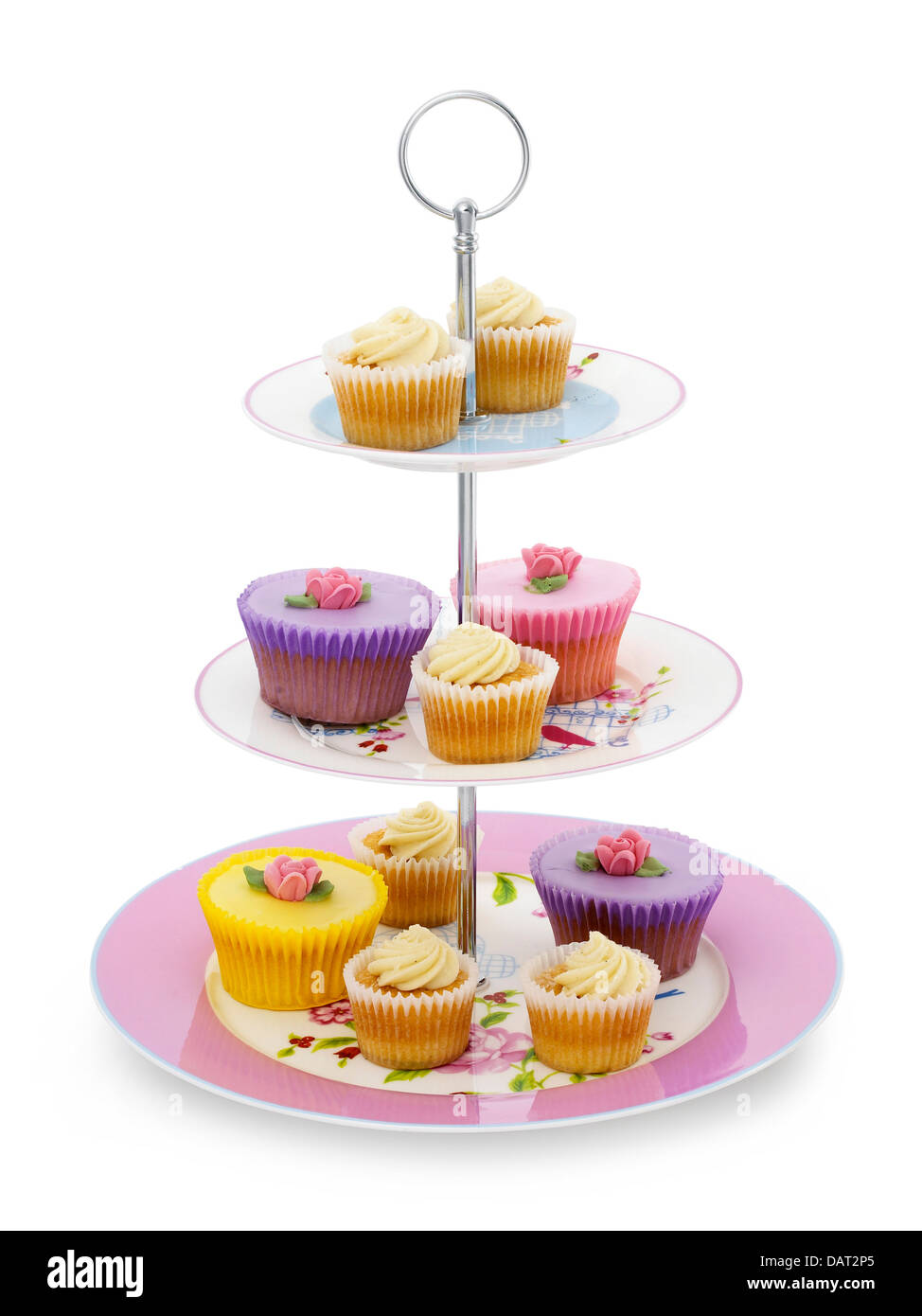 cup cakes displayed on a cake stand cut out onto a white background Stock Photo