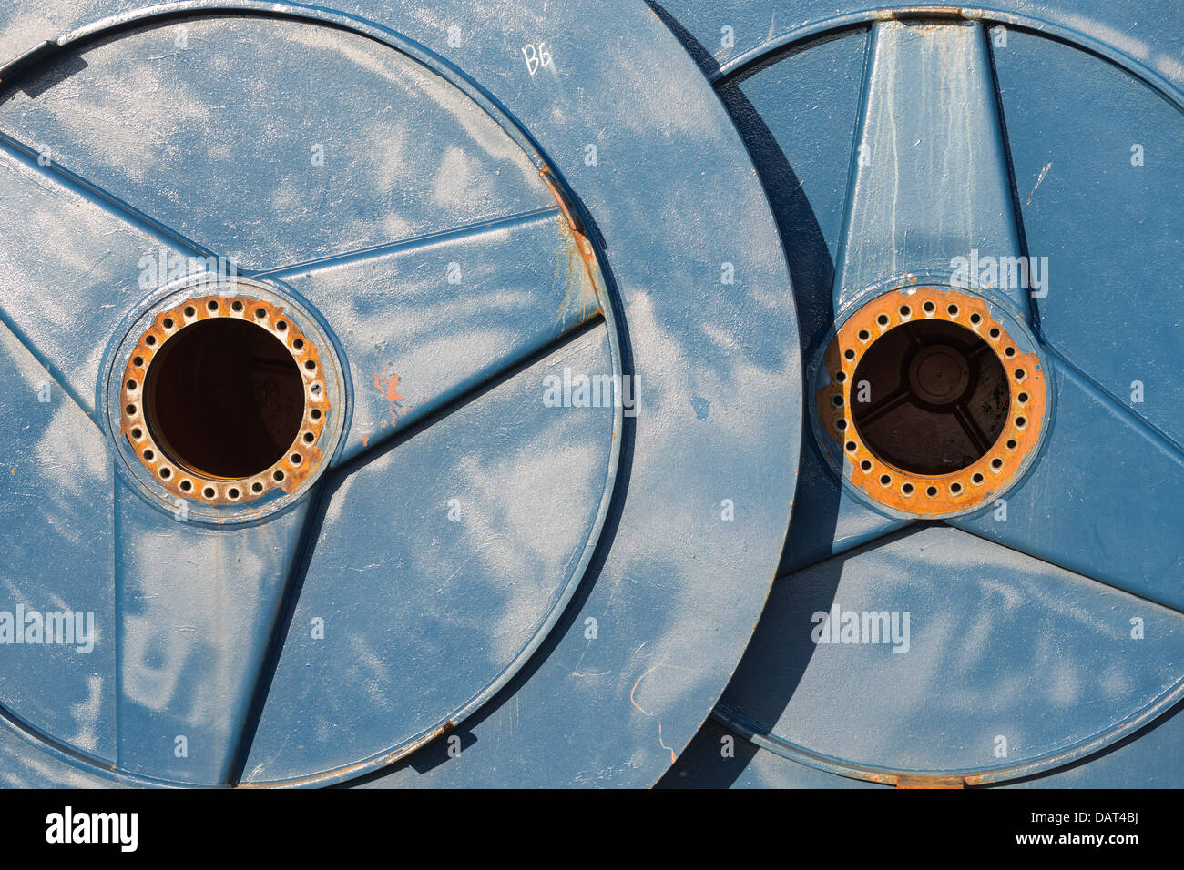 Two big metal spools with hole for drive shaft Stock Photo - Alamy