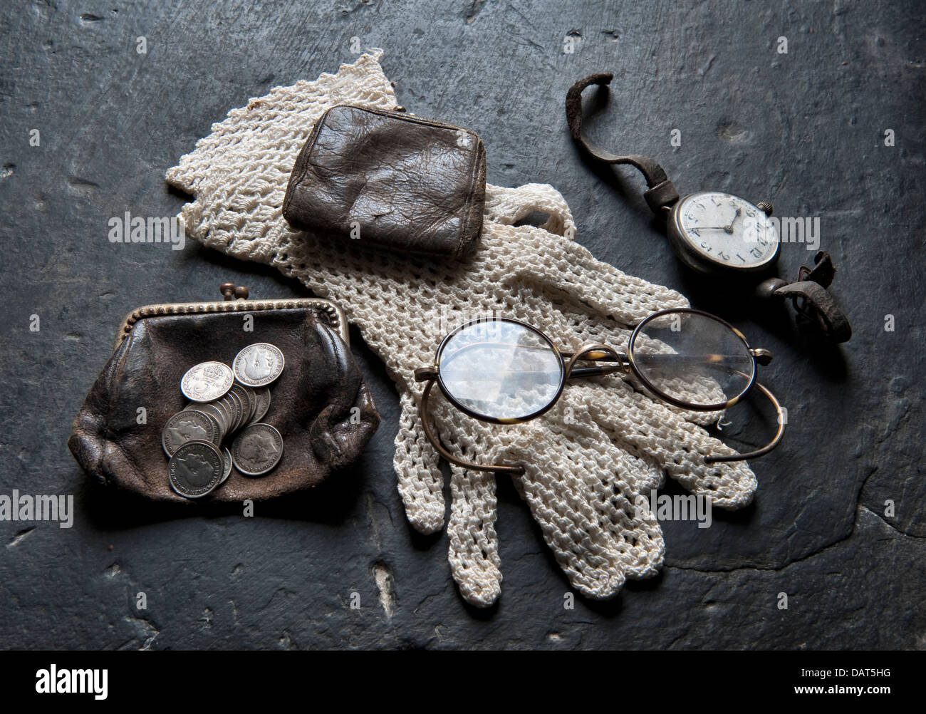 The modest belongings of a lower middle class Edwardian woman - purse, gloves, spectacles, watch etc, in a reconstruction of a typical cottage (UK) Stock Photo