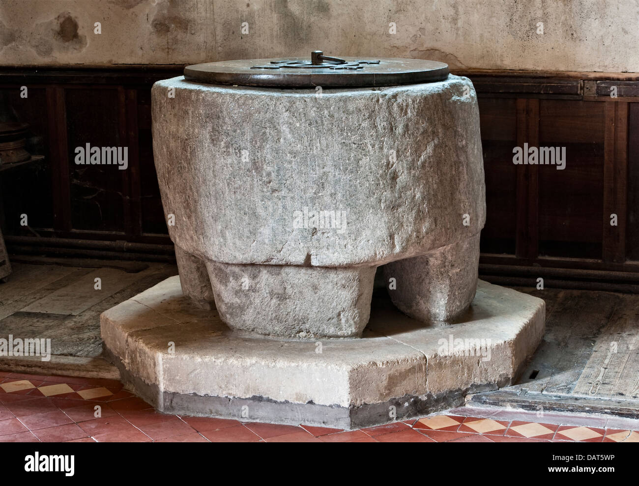 An old pre-Norman stone font dating from the 8th century (possibly an old standing stone) in the 15c St Stephen's Church, Old Radnor, Powys, Wales, UK Stock Photo