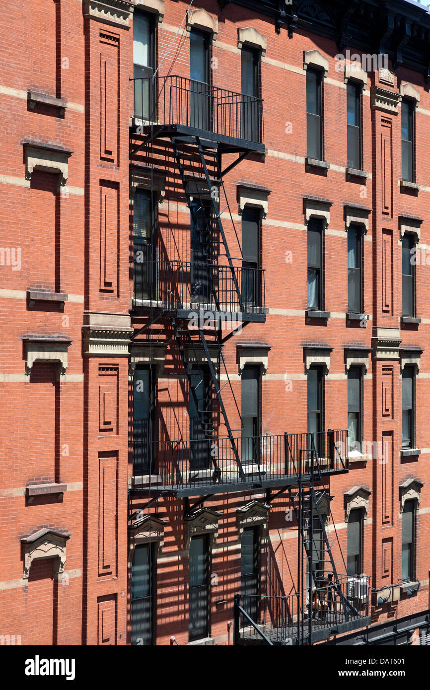 Colorful apartment buildings with fire escapes in New York City Stock Photo