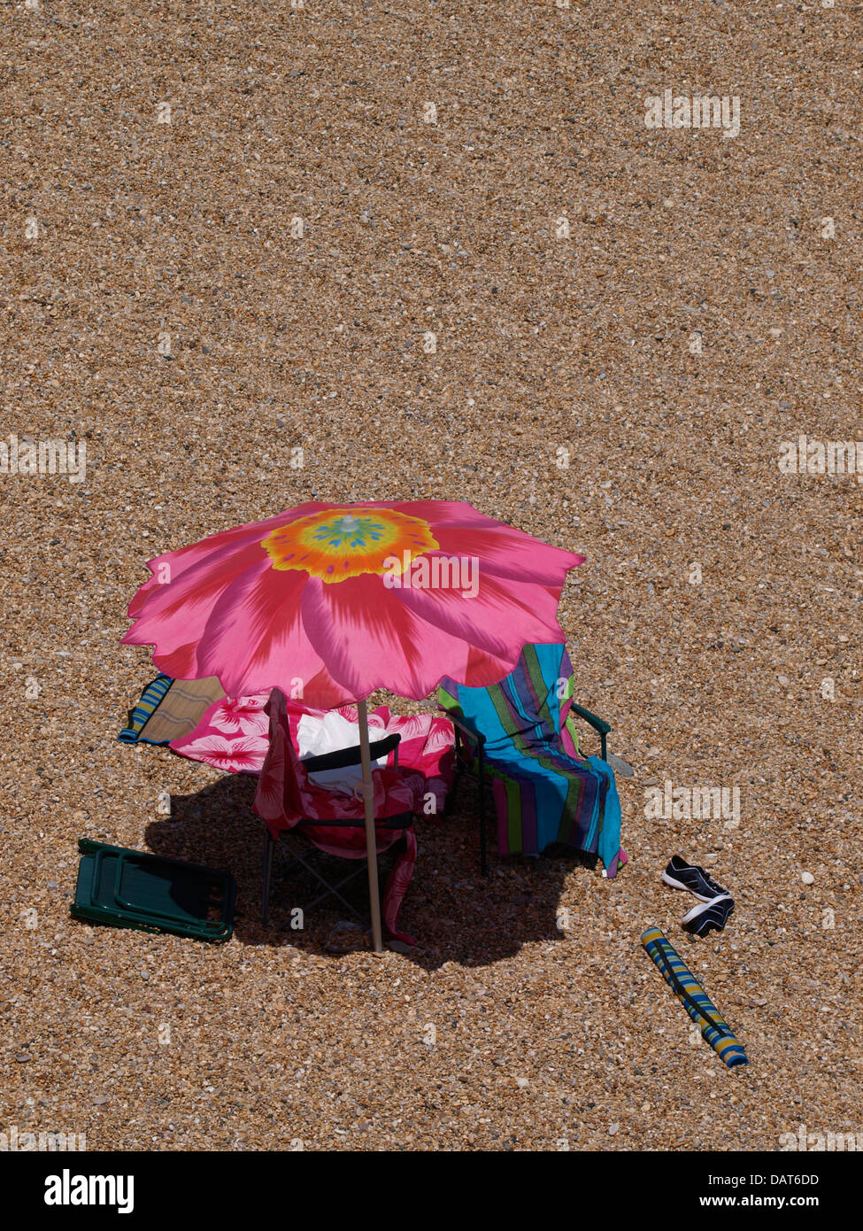 Large flower patterned sun umbrella at the beach, Devon, UK 2013 Stock Photo