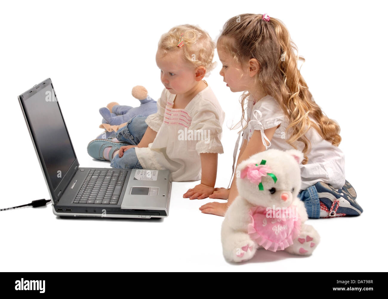 Little girls staring at a notebook computer Stock Photo