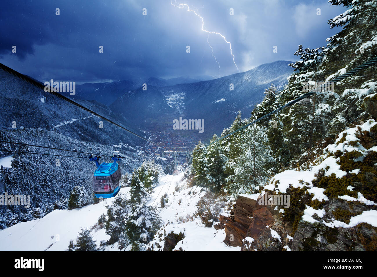 Encamp town in Andorra and cable car and lightning storm over the mountains Stock Photo