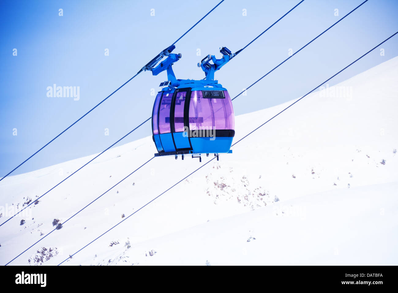 Closeup of cable car for lifting skiers and snowboarders over the ...