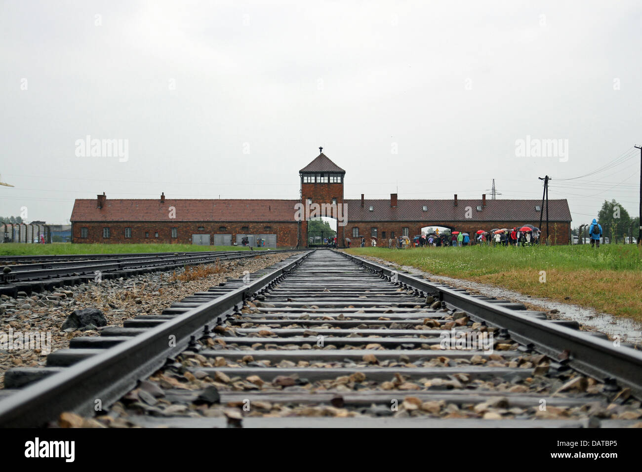 In the distance the main entrance to Auschwitz Birkenau Concentration Camp. Stock Photo