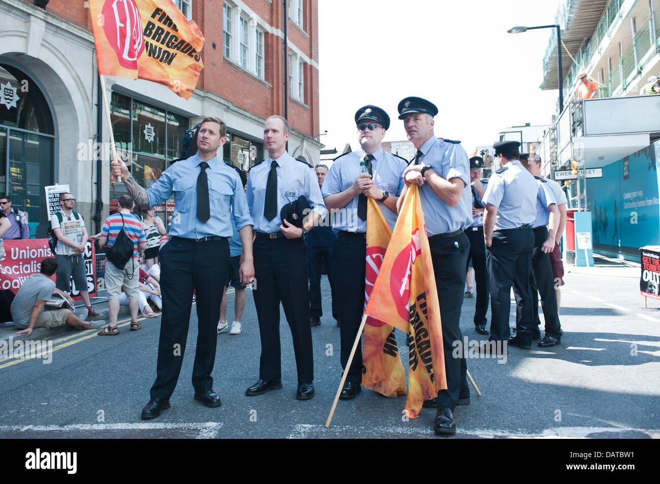 London, UK - 18 July 2013: Fire brigaders waive flags of the Fire Brigade union Credit:  Piero Cruciatti/Alamy Live News Stock Photo