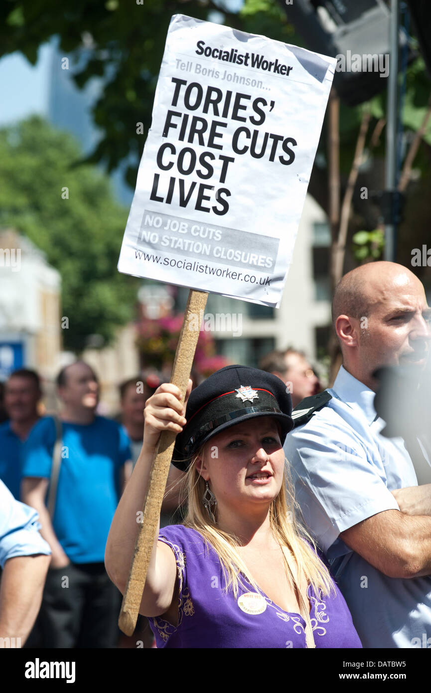 London, UK - 18 July 2013: a woman holds a placard r eading 'Tories' fire cuts cost lives' as hundreds of protesters gather to demonstrate against controversial service cuts to the London Fire Brigade which could see the closure of 10 stations. Credit:  Piero Cruciatti/Alamy Live News Stock Photo