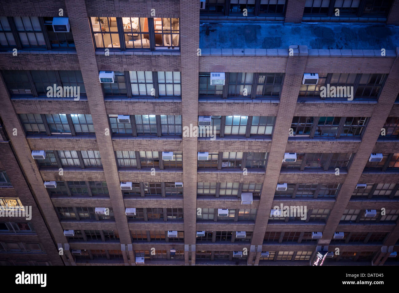 Air conditioners sprout from windows in an office building in New York