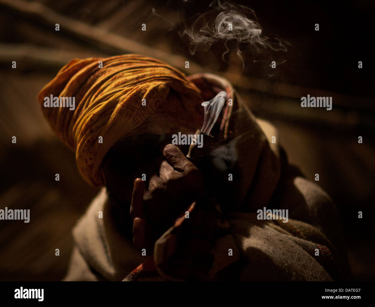 Portrait of a local villager smoking a pipe at the Kumbh Mela 2013 in Allahabad, India Stock Photo