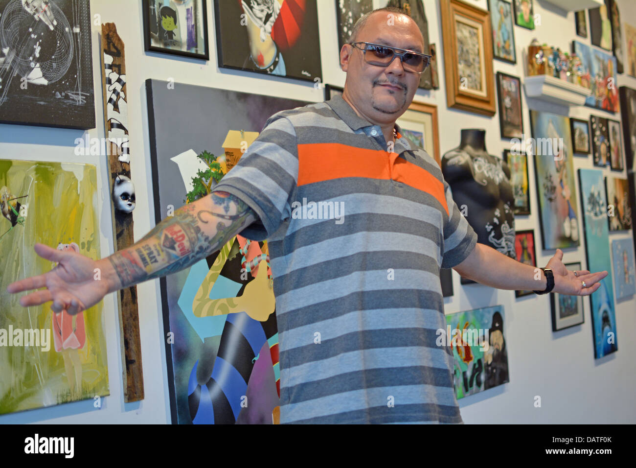 Portrait of a graffiti artist Zimad in front of his work at an exhibition at Low Brow Artique in Bushwick, Brooklyn, New York Stock Photo