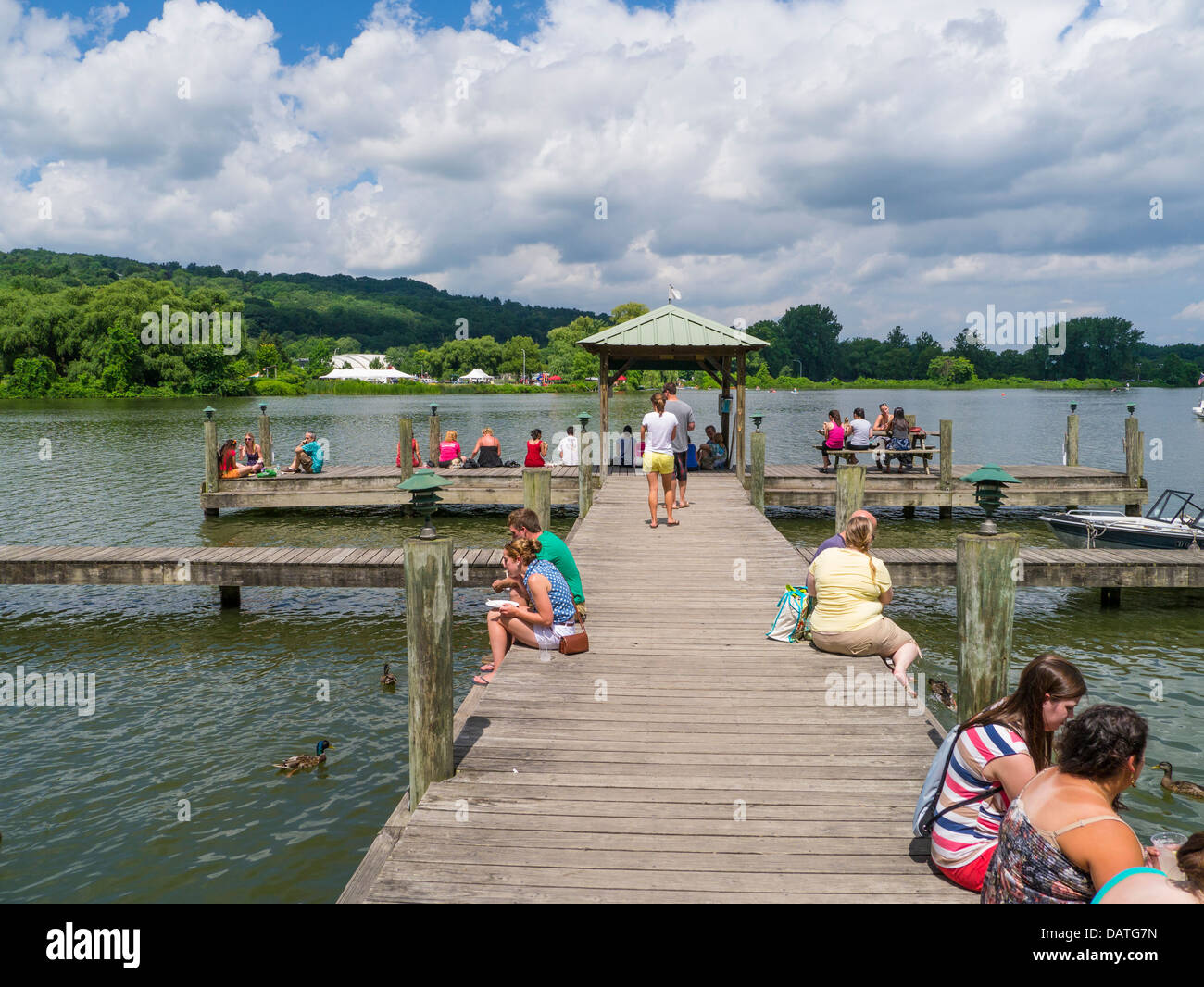 People enjoying summer day on Cayuga Inlet at Steamboat Landing in the