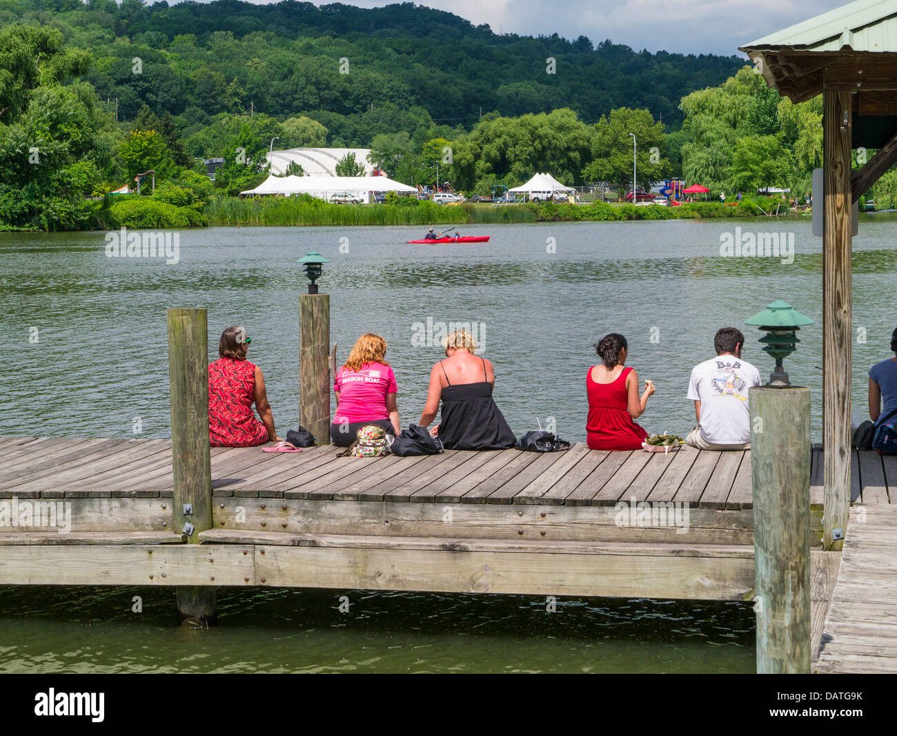 People enjoying summer day on Cayuga Inlet at Steamboat Landing in the