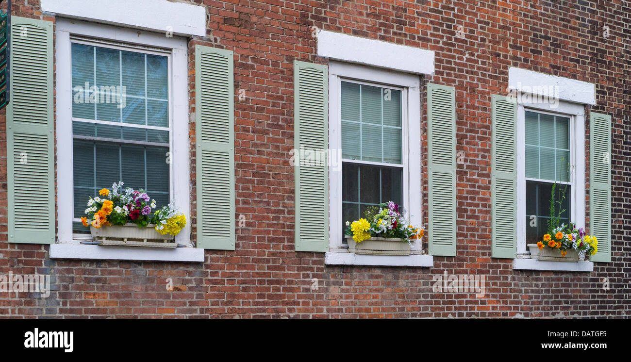 Flower window boxes on brick house in Watkins Glen New York in the Finger Lakes Region of NY State Stock Photo