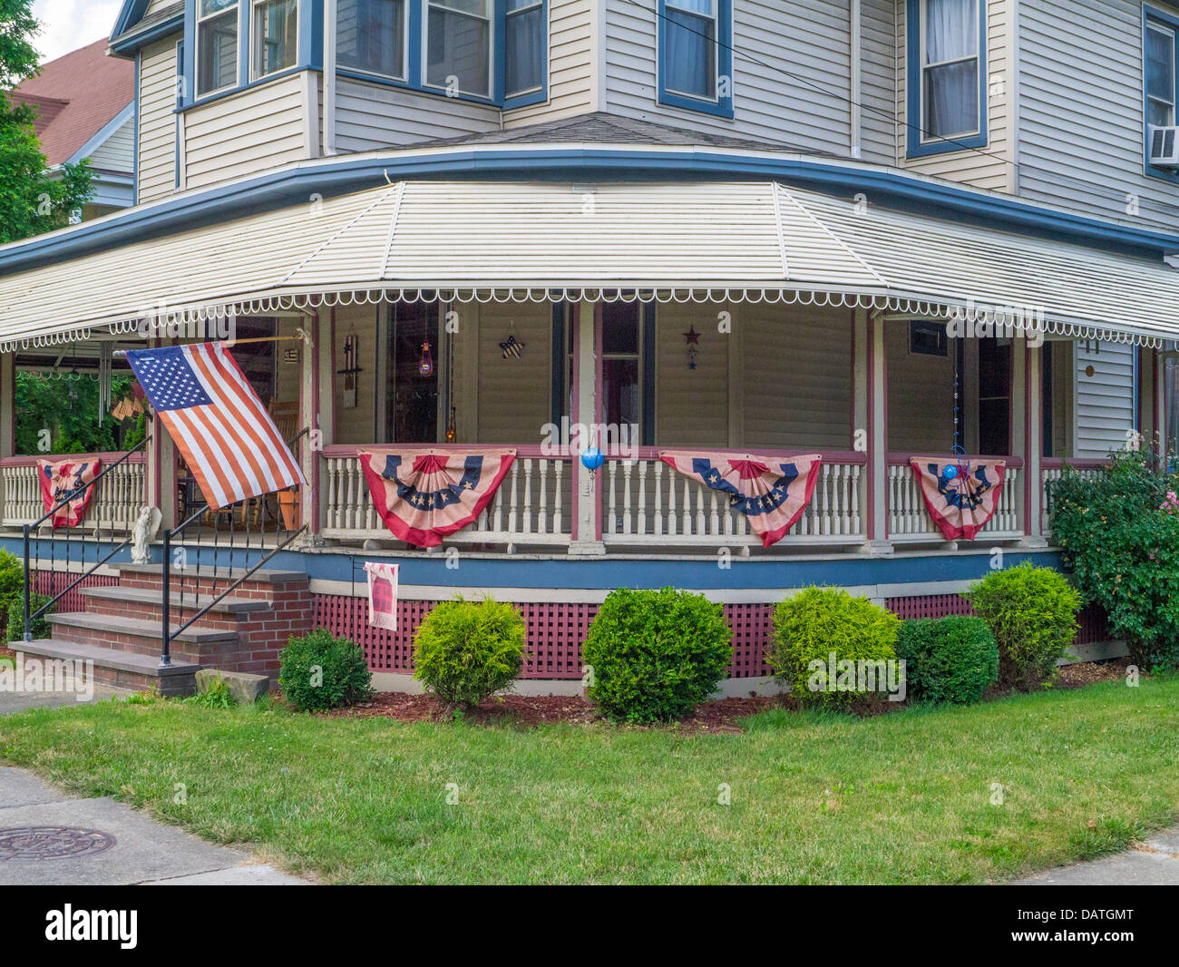 House with flags on porch railings in Watkins Glen New York in the