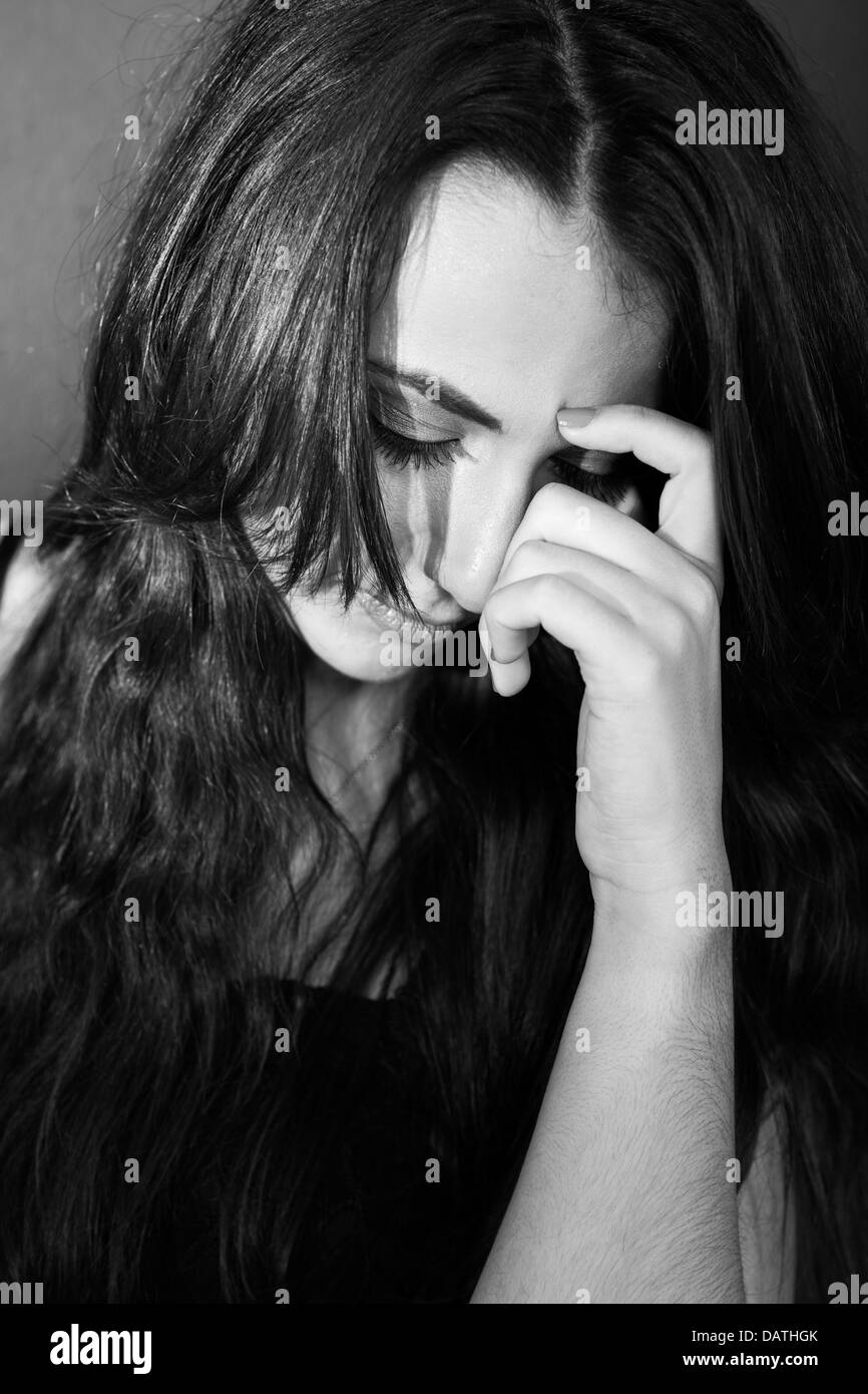 sad young woman looking down Stock Photo
