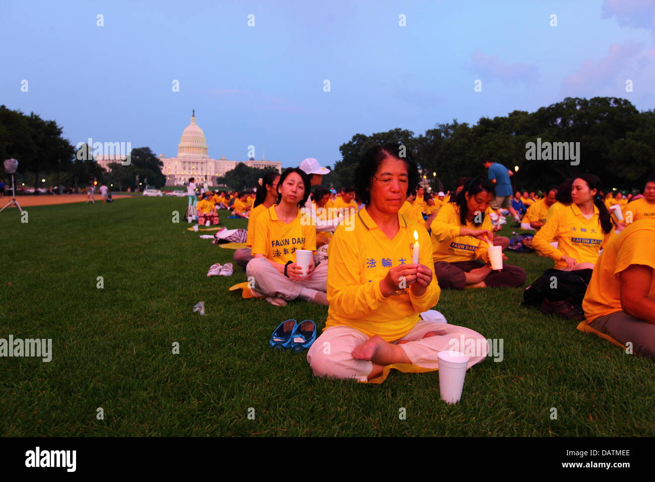Washington DC, USA. 18th July, 2013. Falun Gong members commemorate the 14th anniversary of the Chinese government crackdown against them which began on 20th July 1999. In the background is the United States Capitol Building. Credit:  James Brunker / Alamy Live News Stock Photo