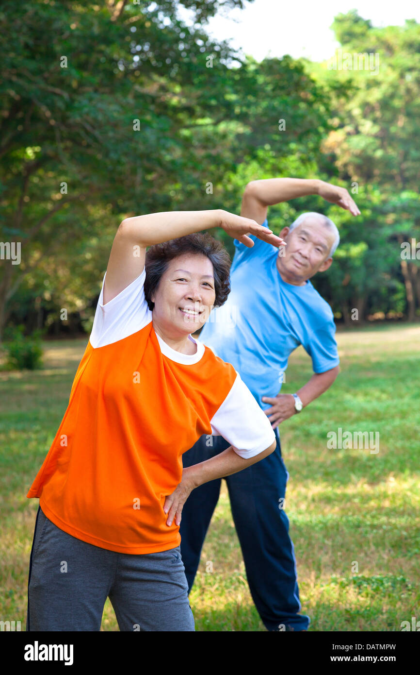 Happy asian senior fitness couple in the park Stock Photo - Alamy