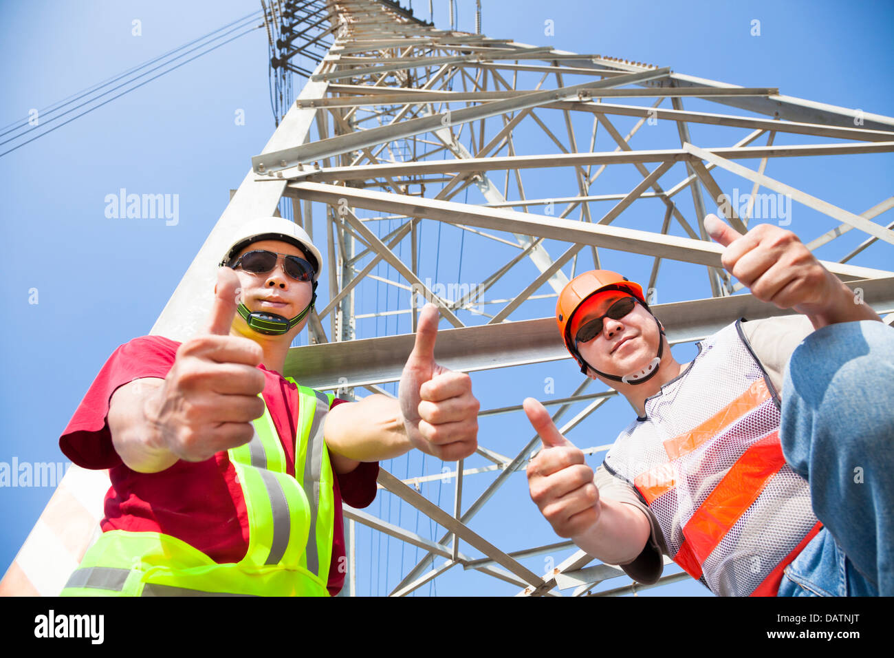 two power line workers with thumbs up Stock Photo Alamy