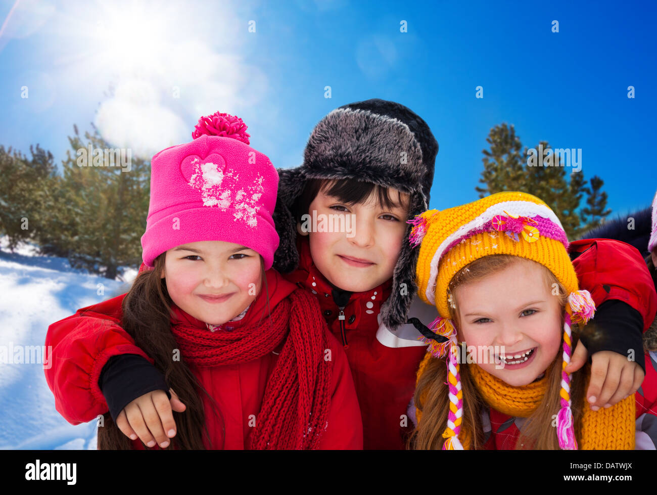 Three diversity looking kids - two girls and a boy outside on sunny winter day Stock Photo