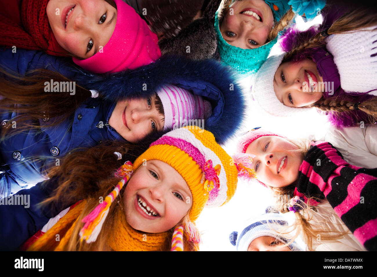 Group of happy kids look down wearing winter clothes Stock Photo - Alamy