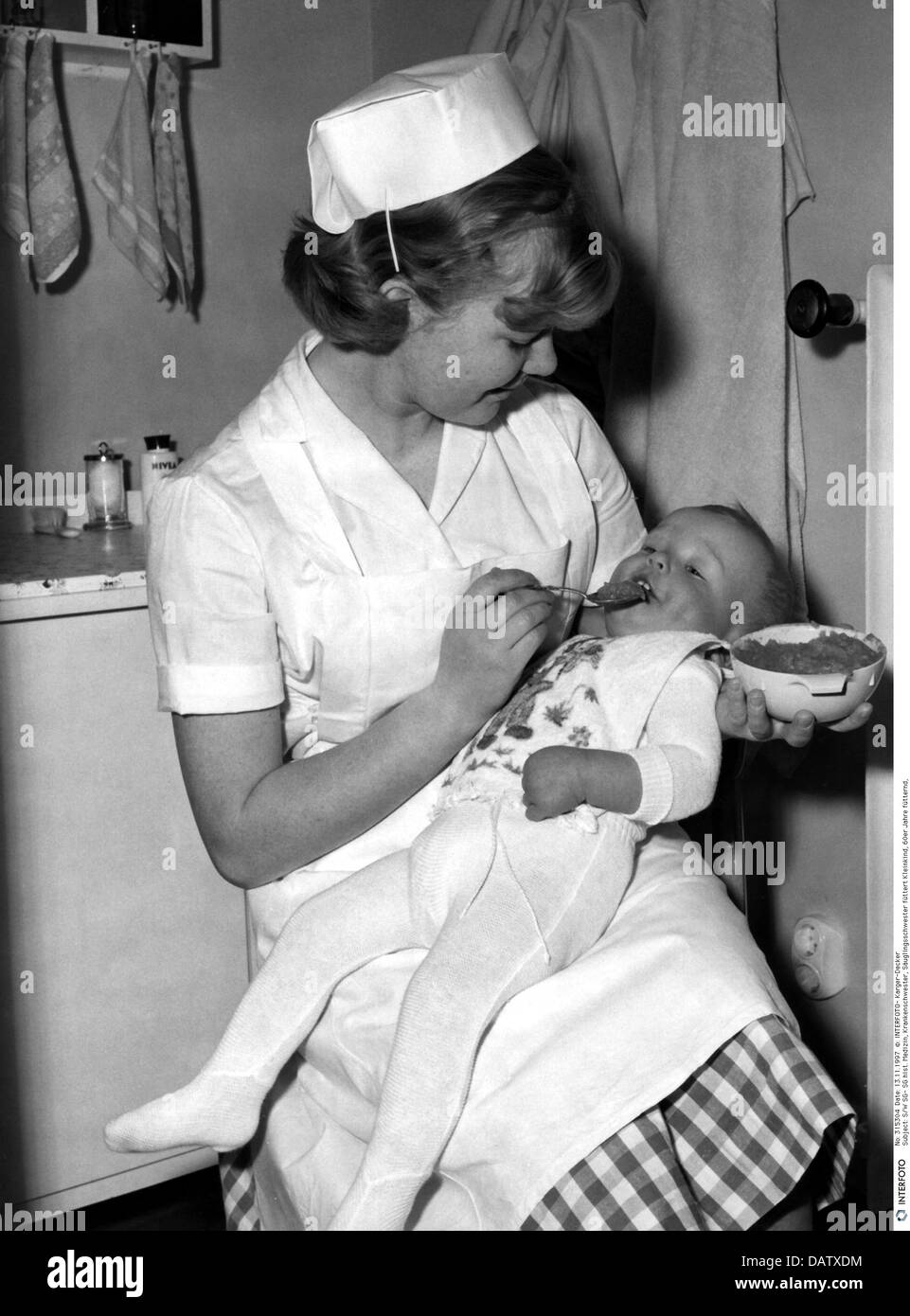 medicine, nurse, baby nurse feeding baby, 60s Stock Photo 58325280 Alamy