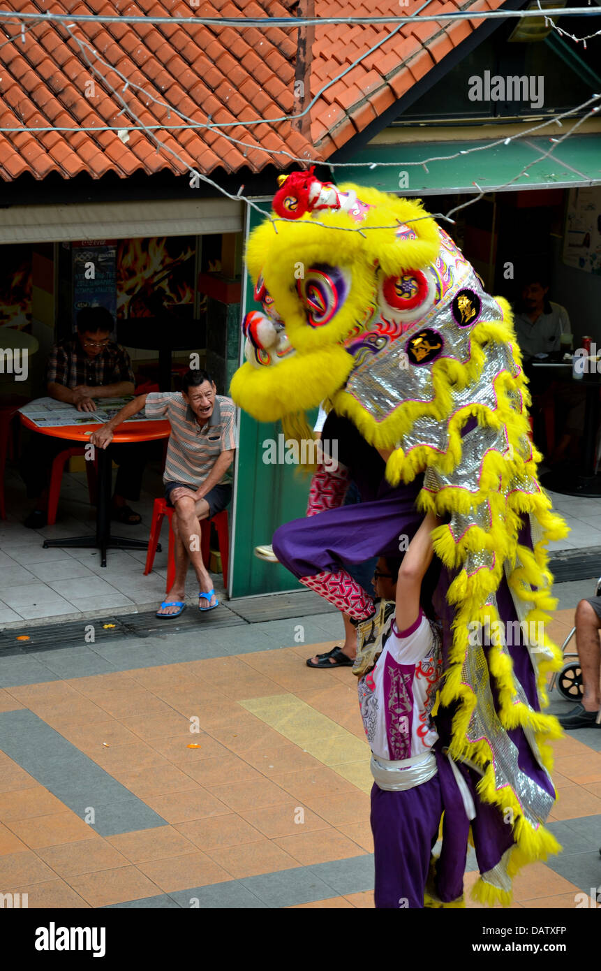 Man watches traditional Chinese Lion Dance Stock Photo