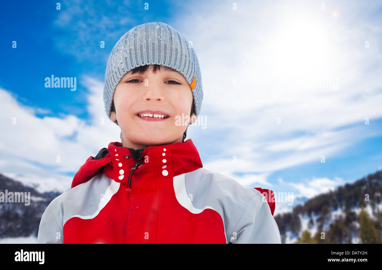 Face portrait of happy 10 years boy on winter day, wearing red clothes Stock Photo