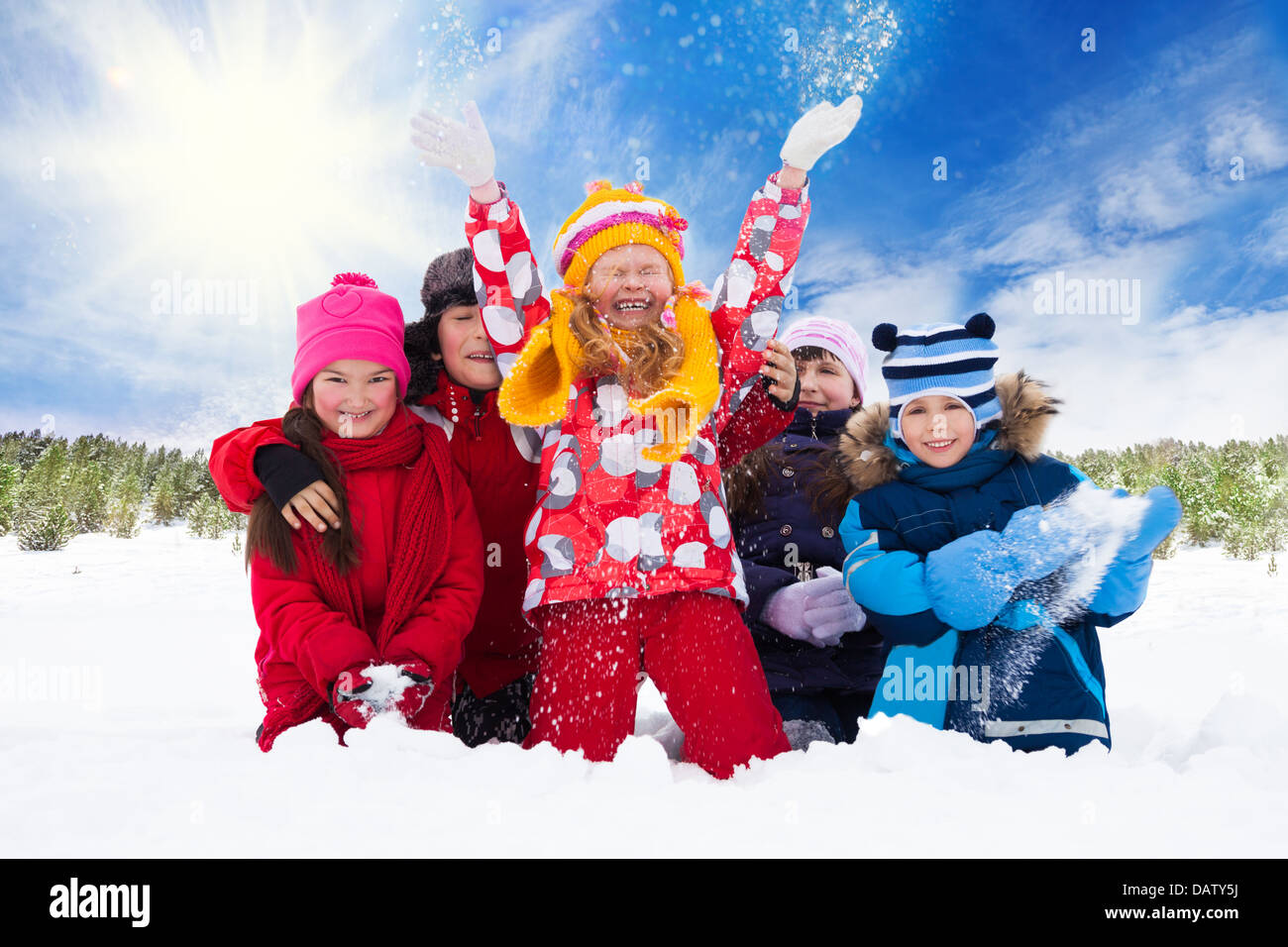 Group of five happy kids, boys and girls throw snow in the air Stock ...