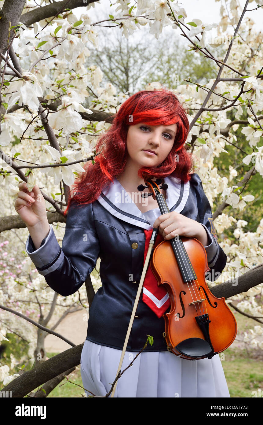 Teenage girl with a violin in the blooming garden Stock Photo - Alamy