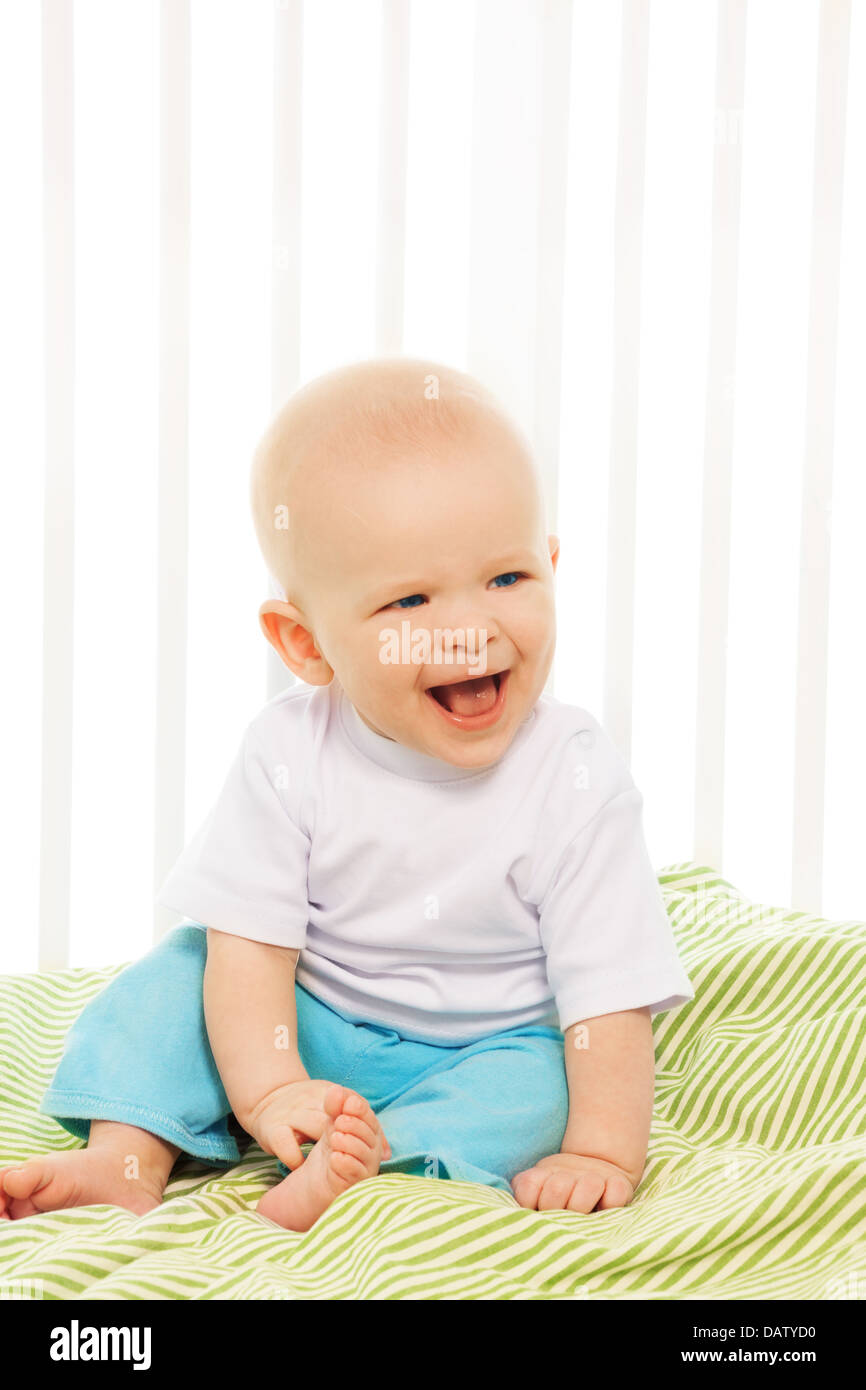 Curious baby boy sitting on bed hi-res stock photography and images - Alamy