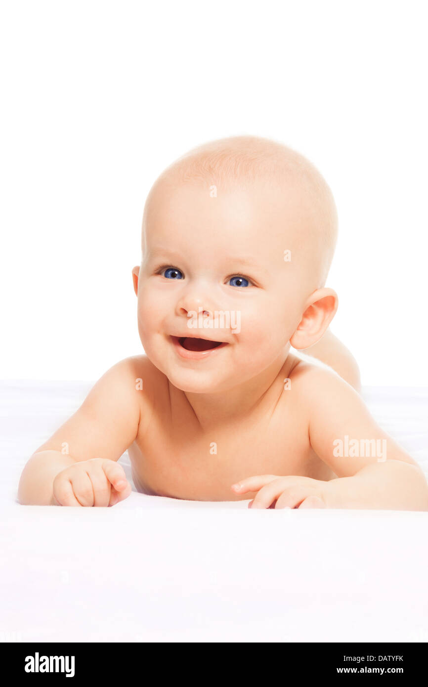 Happy 6 month old little boy laying on the blanket and smiling Stock Photo