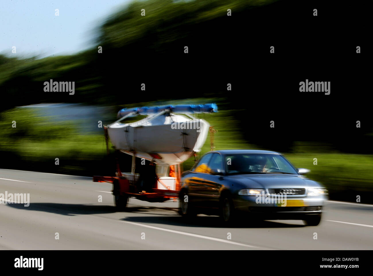 A car pulling a boat is driven on the autobahn in Cologne, Germany, 19
