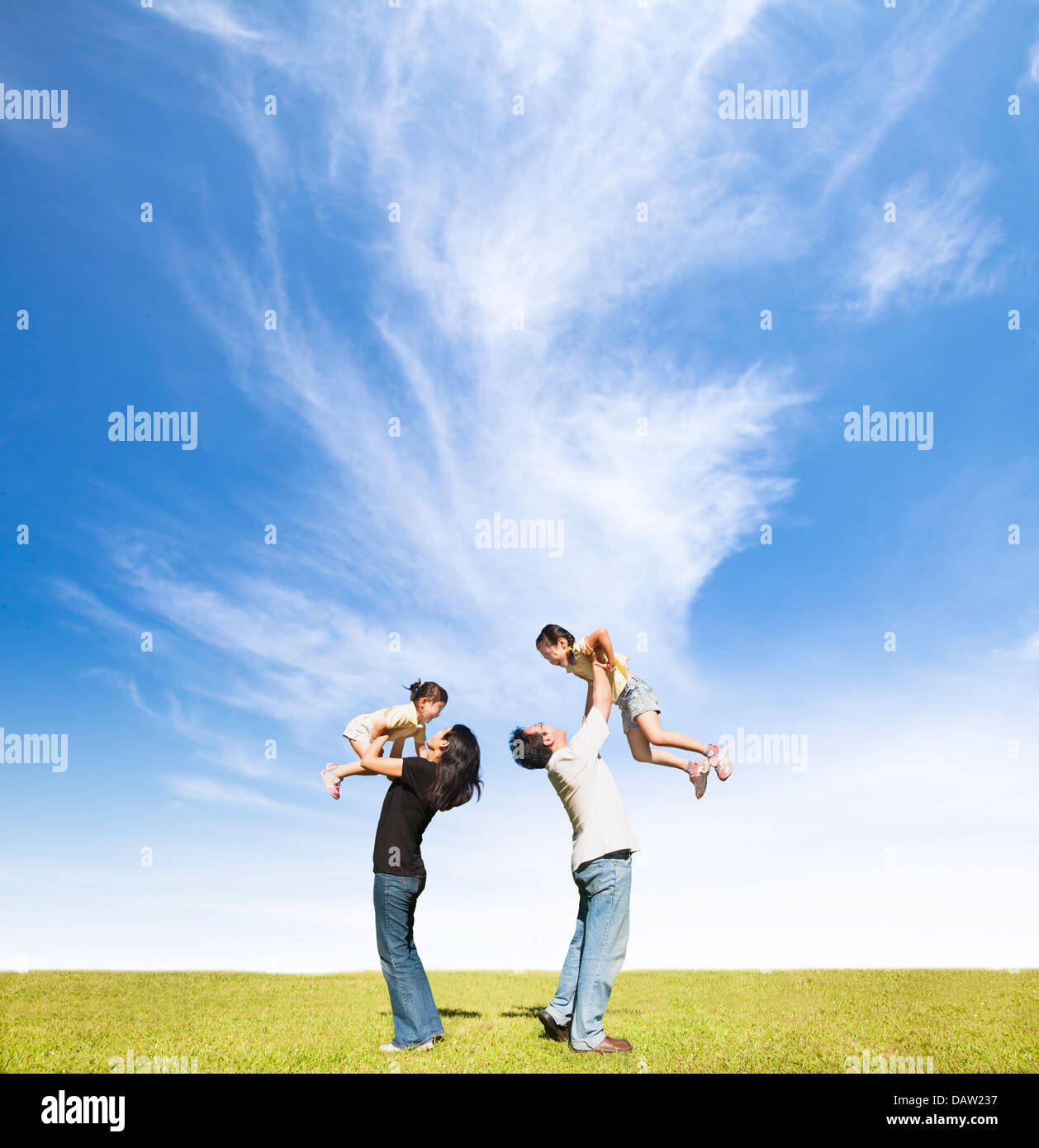 happy family on the grass with cloud background Stock Photo - Alamy