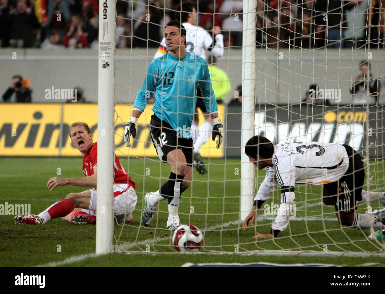 German national team player Kevin Kuranyi starts to celebrate his 2-0 goal while Swiss players Stephane Grichting and goalkeeper Diego Benaglio are shocked during a routine international friendly at the LTU Arena stadium in Duesseldorf, Germany, Wednesday, 07 February 2007. Germany cruised to a comfortable 3-1 win over Switzerland with goals from Kuranyi, Gomez and Frings. Photo: A Stock Photo