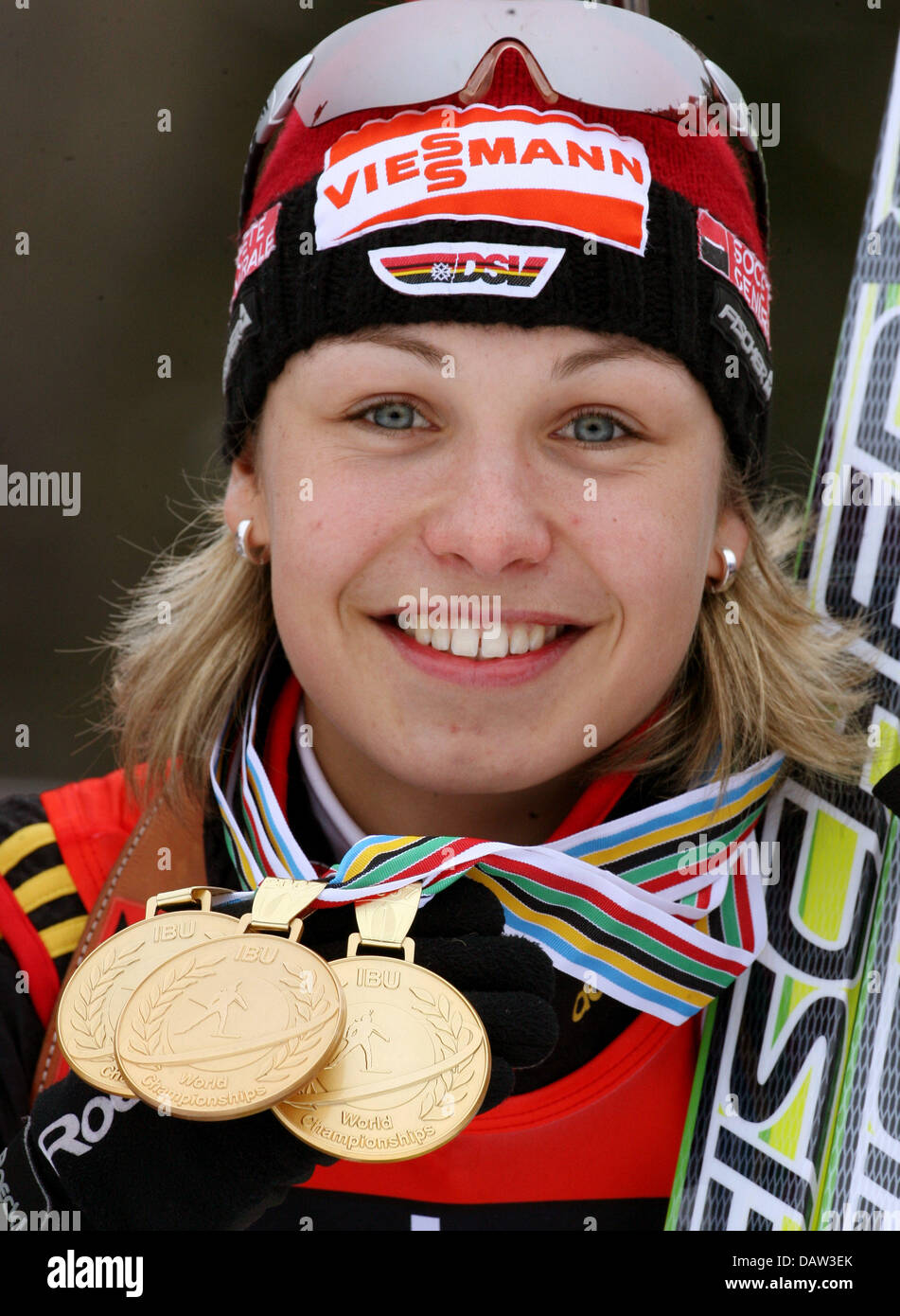 German biathlete Magdalena Neuner poses with her three gold medals won at the Biathlon World Cup in Antholz, Germany, 11 February. Photo: Martin Schutt Stock Photo
