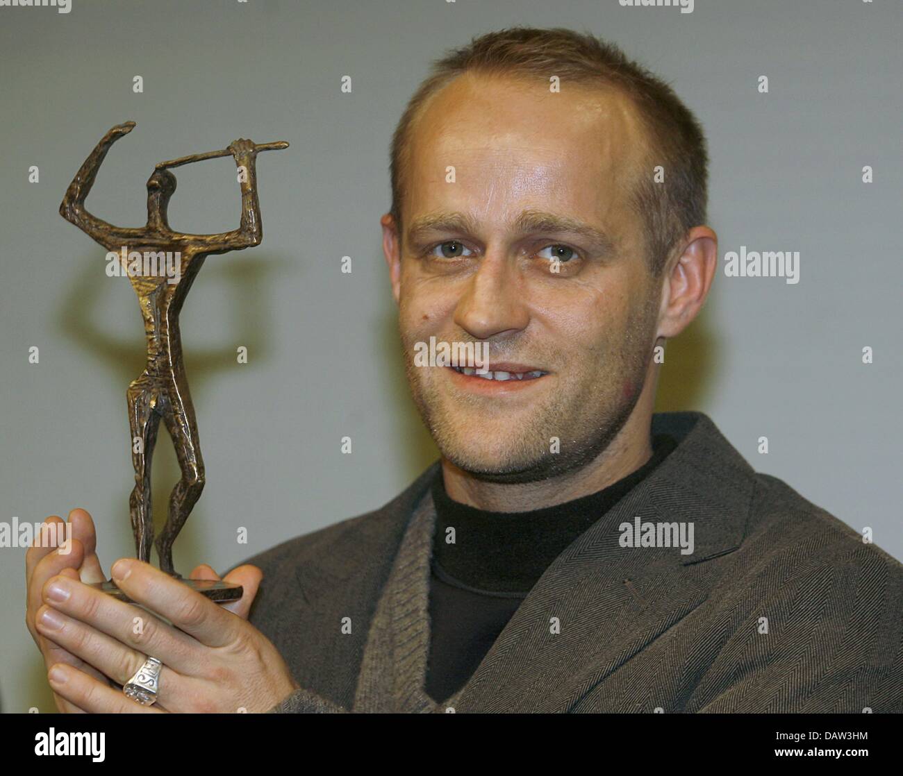 German actor Juergen Vogel smiles with his Ernst Lubitsch Prize in 