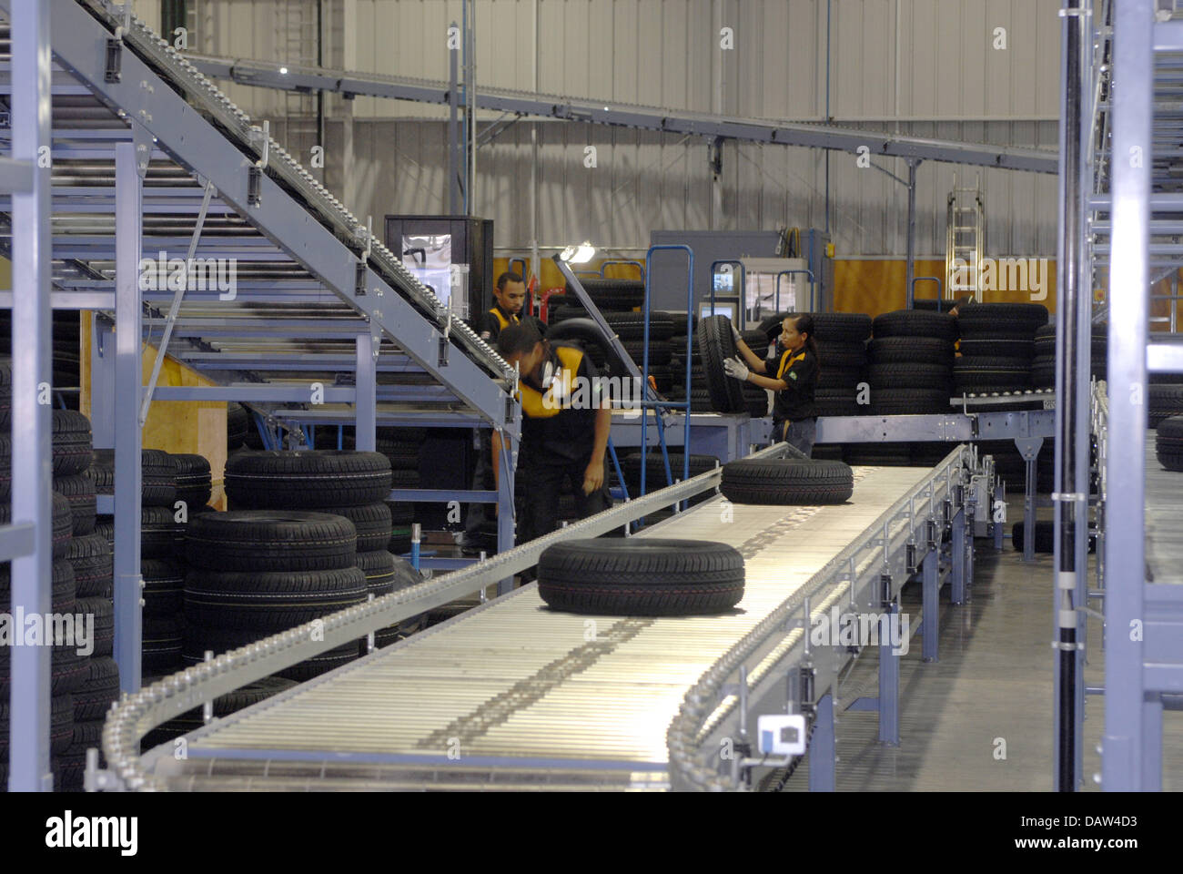 (dpa file) Employees of Continental Brazil control and finish tyres in the company's factory of Salvador, Brazil, 20 August 2006. Photo: RiKa Stock Photo