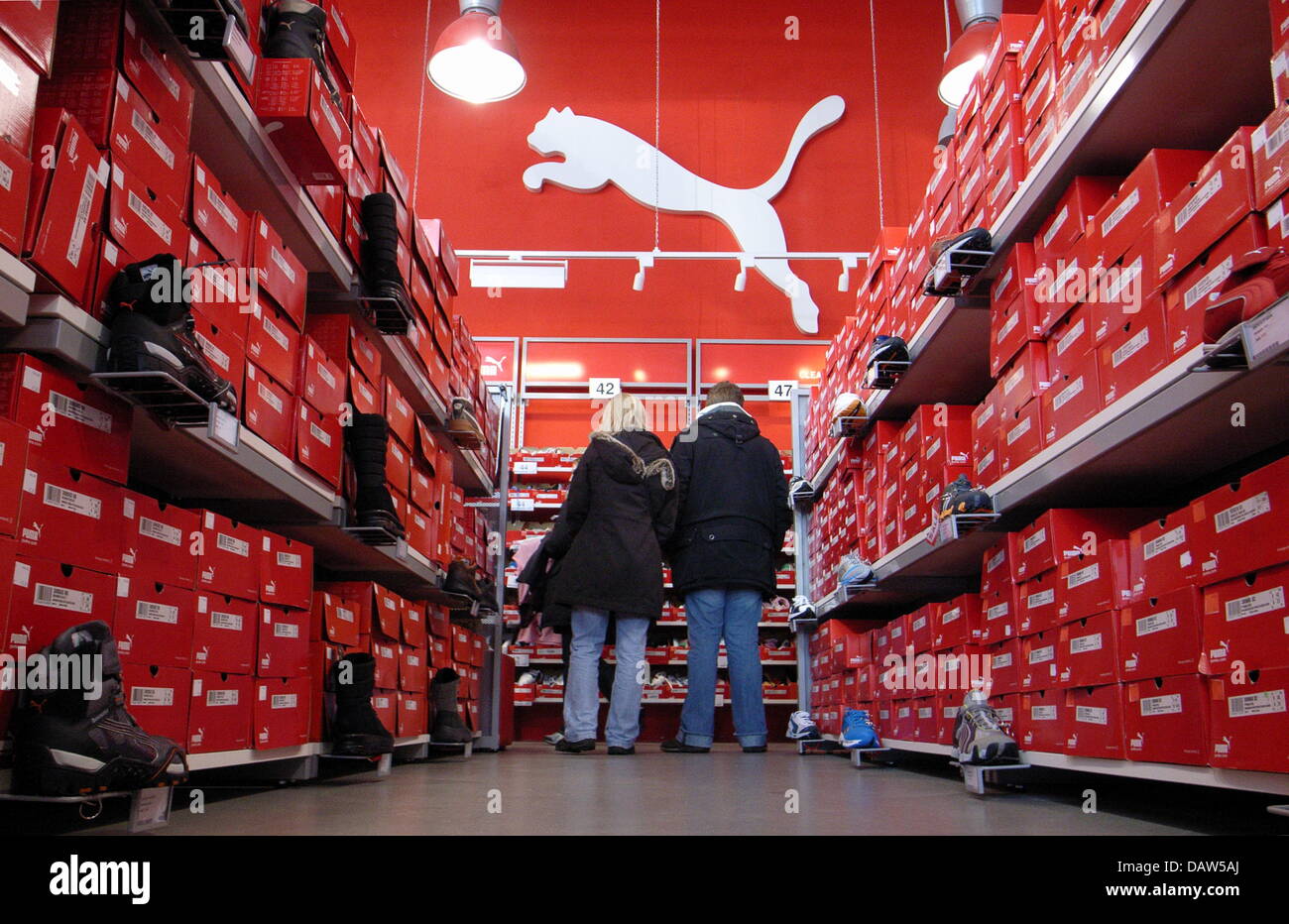 Two customer look for shoes at a PUMA outlet store in Bremen Stock ...