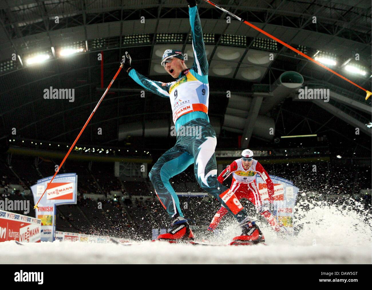 Hannu Manninen of Finland raises his arms in triumph after taking gold