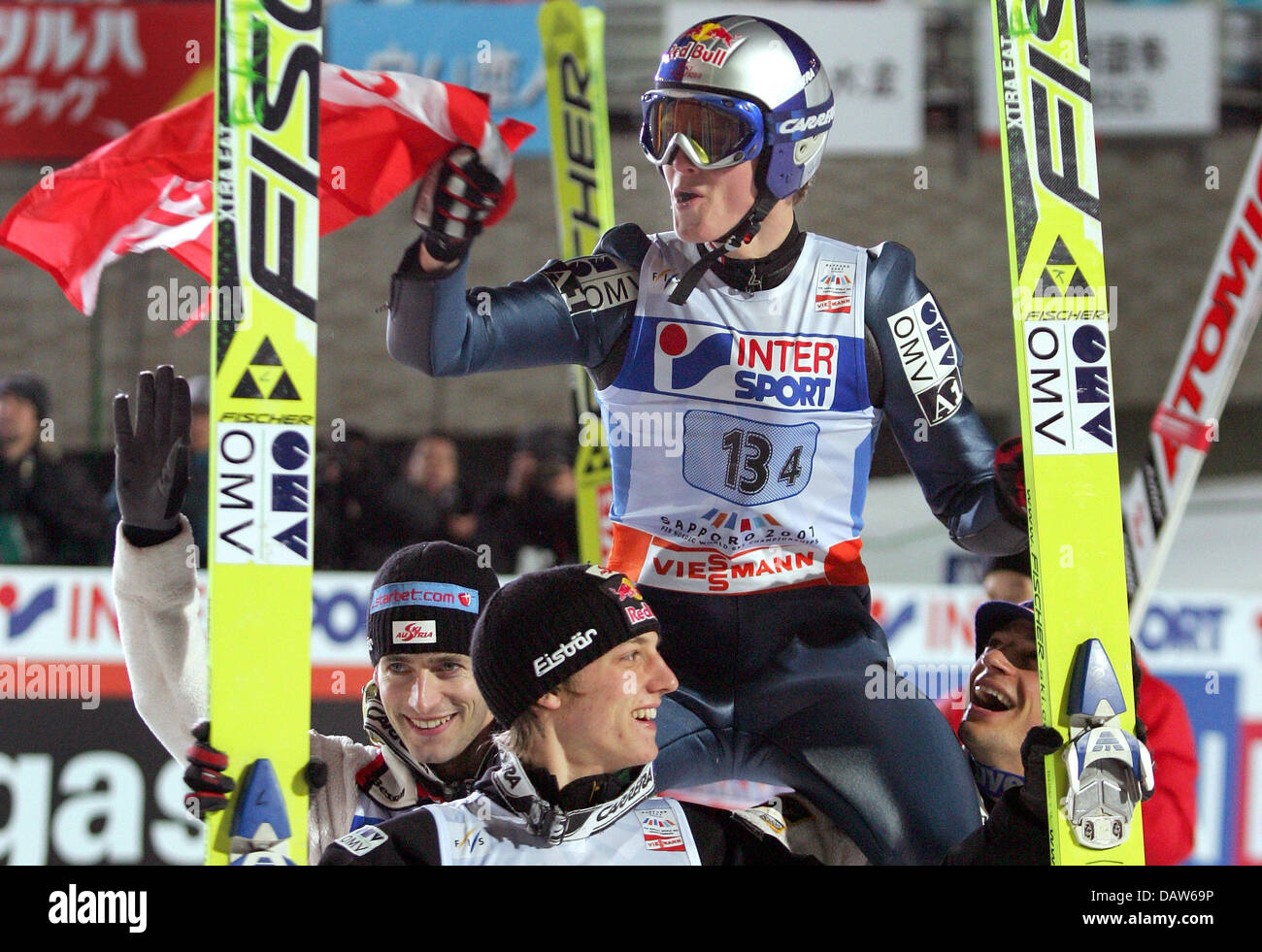 Austrian ski jumper Thomas Morgenstern (top) is cheered by his team-mates (bottom L-R) Wolfgang Loitzl, Gregoer Schlierenzauer and Andreas Kofler for bringing home the Austrian triumph at the Lage Hill Team of the Nordic World Ski Championships in Sapporo, Japan, 25 February 2007. Austria finished with a massive total of 1,000.2 points outclassing second placed Norway and suprise t Stock Photo