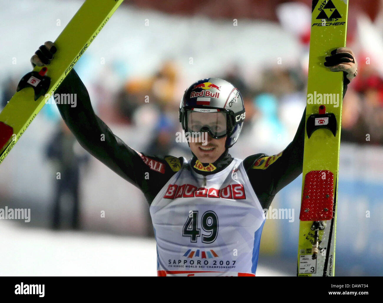 Polish ski jumper Adam Malysz cheers winning the normal hill individual 