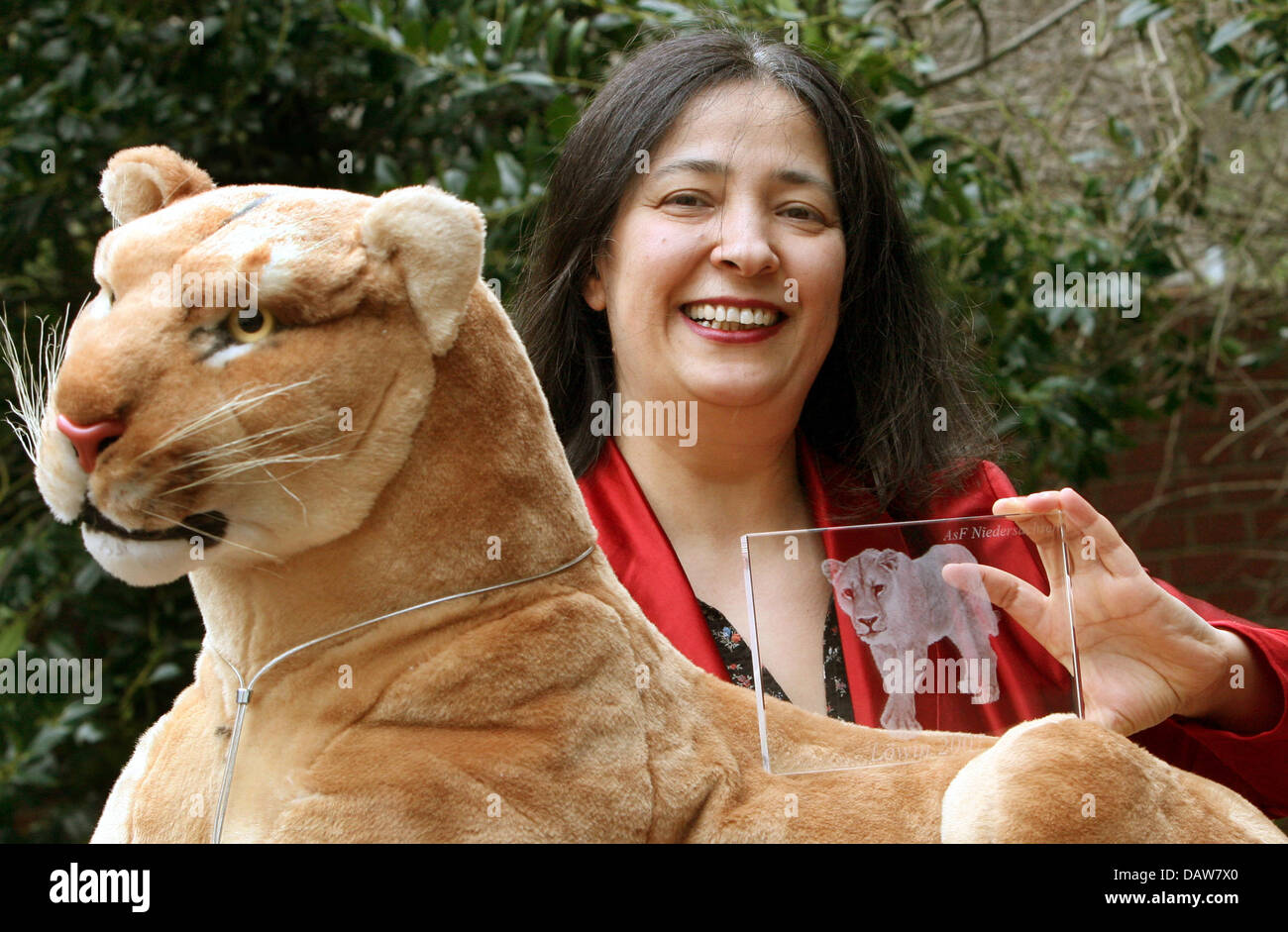 Women's and peace activist Seyran Ates poses with the award 'Loewin 2007' behind a plush lion in Hanover, Germany, Wednesday, 7 March 2007. She was awarded the prize for her engagement against the so-called honour killings of women in Islamic families by the lower saxonian group of social democratic women (Niedersaechsische Arbeitsgemeinschaft Sozialdemokratischer Frauen (ASF) ). P Stock Photo