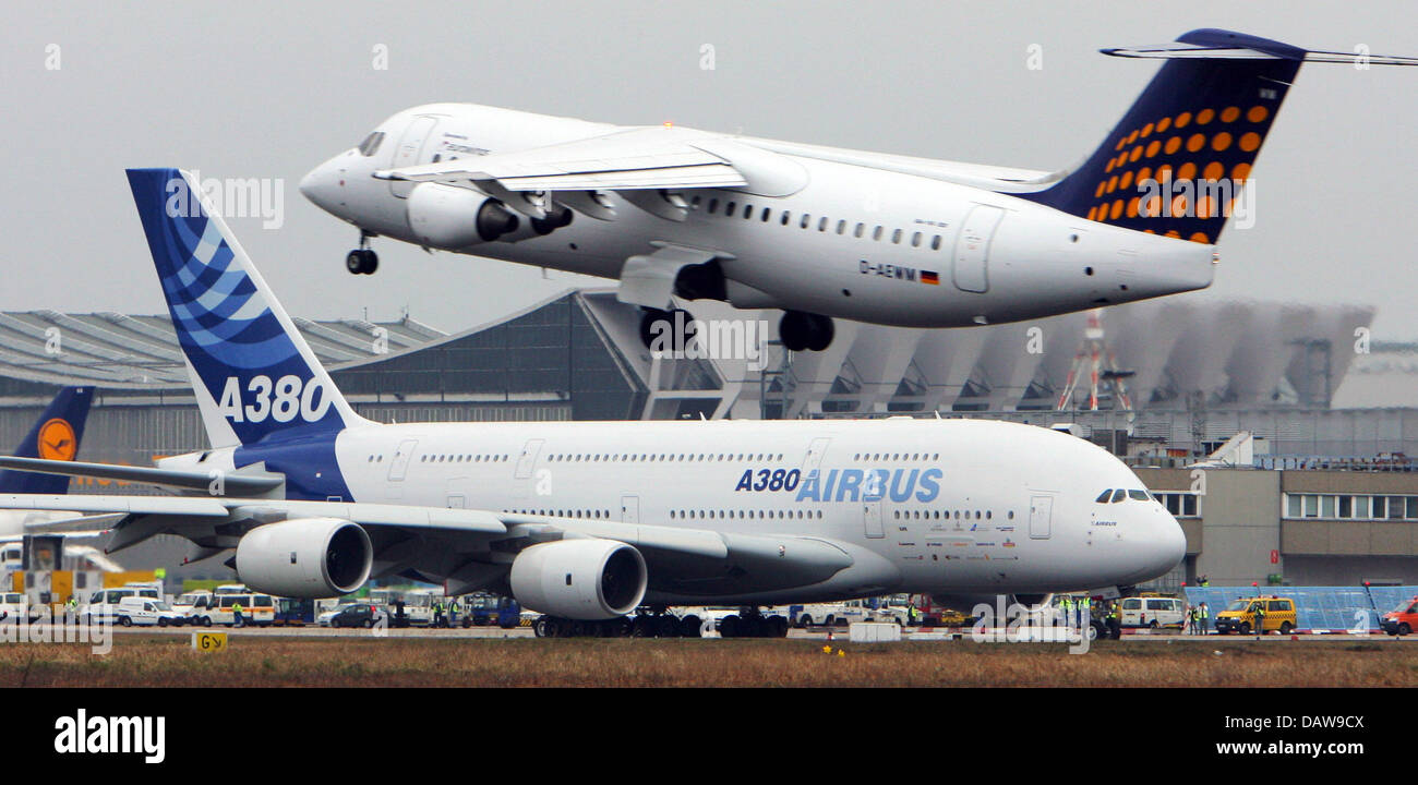 The new wide-bodied aircraft Super-Airbus A380 pictured after landing while a small jet takes off in the background at the international airport in Frankfurt Main, Germany, Saturday 17 March 2007. The new plane will fly as a Lufthansa-flight with 500 passangers on board from Frankfurt to New York for the first time on Monday. Further destinations are Hong Kong, Washington and Munic Stock Photo