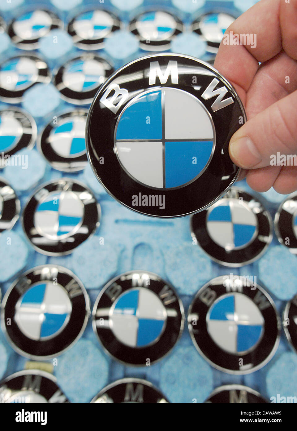 An employee of German carmaker BMW takes a famous blue and white 
