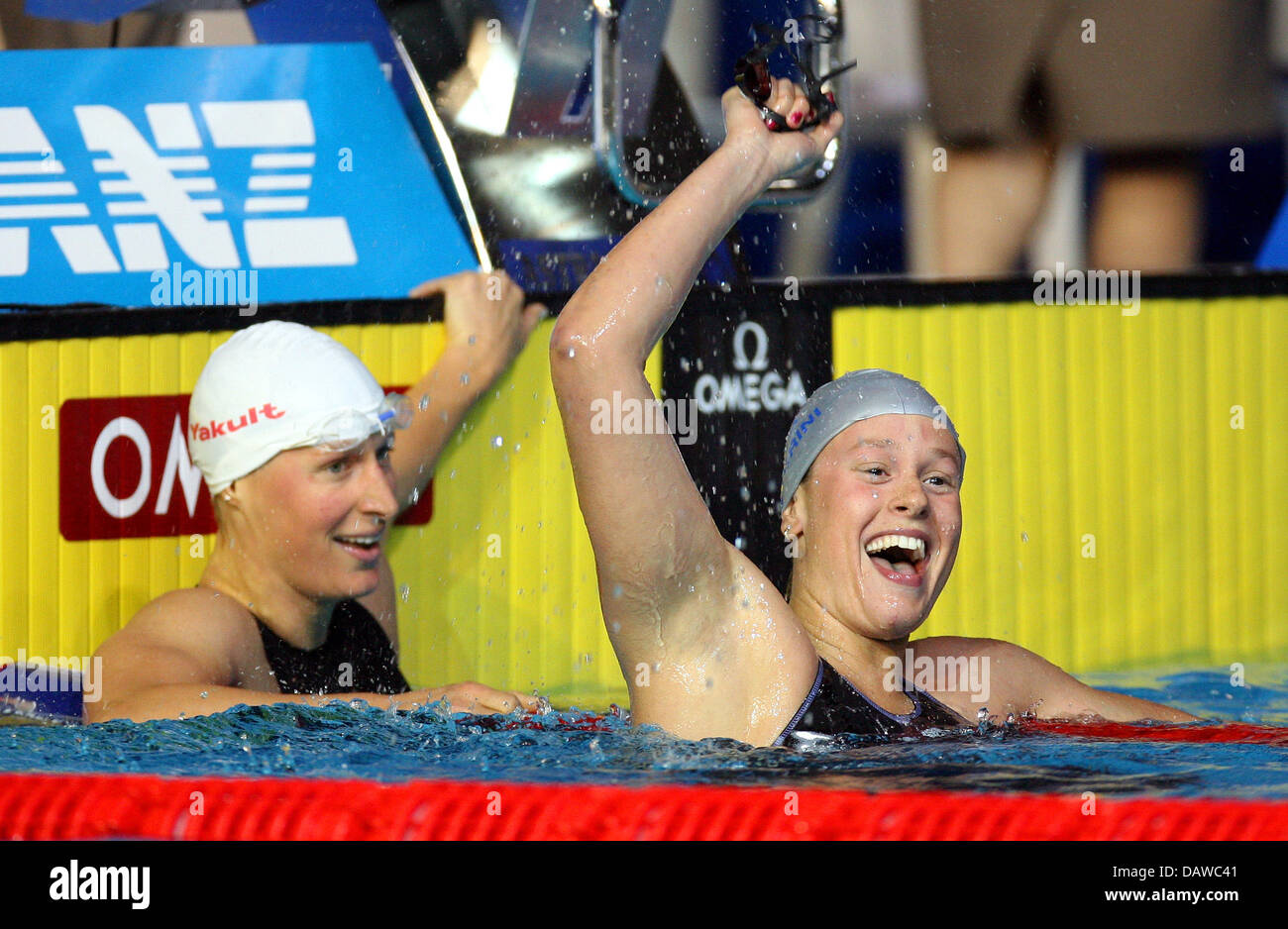 Italian swimmer Federica Pellegrini (R) cheers winning ahead of German