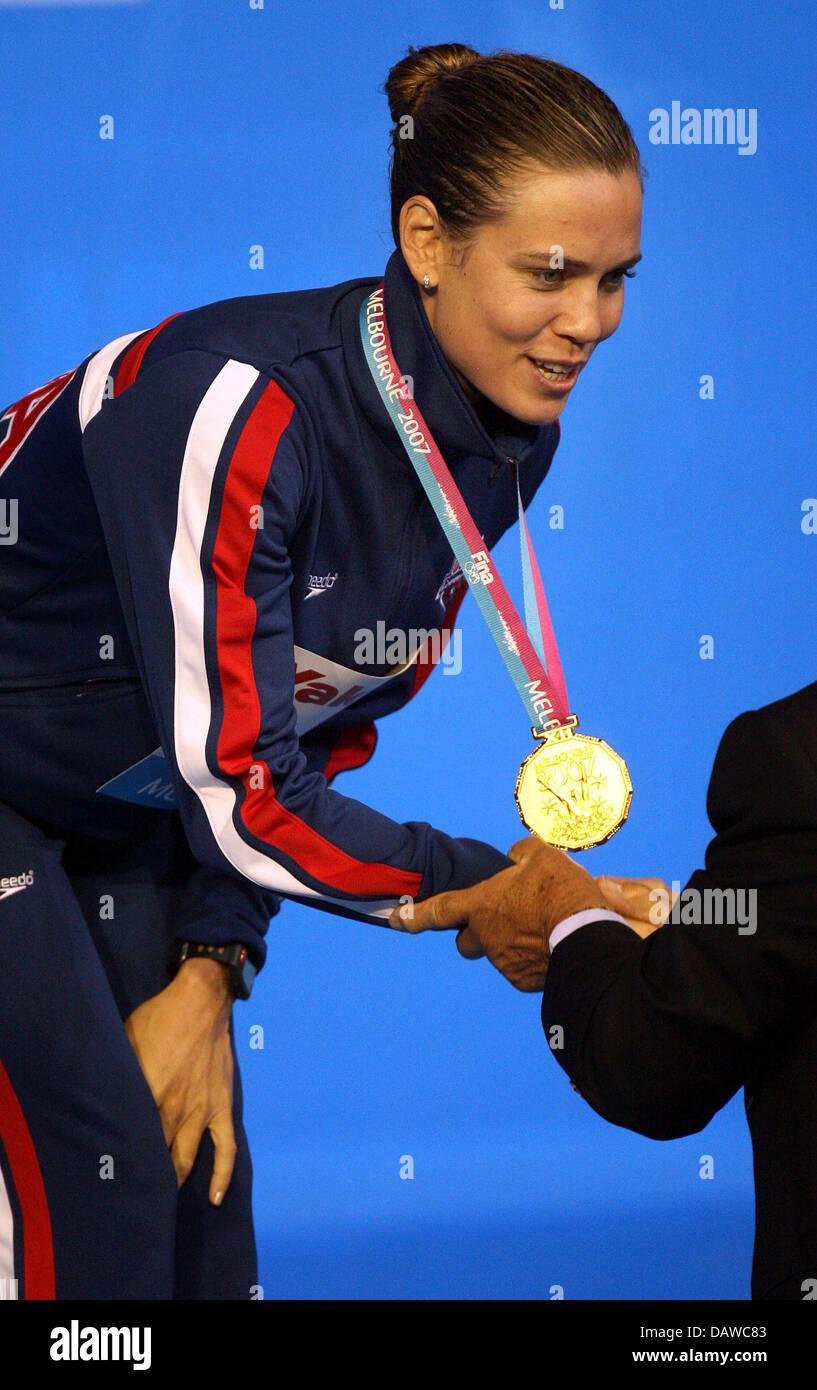 US swimmer Natalie Coughlin is decoreated with the gold medal for the Women's 100m Backstroke of the 12th FINA WAorld Championships in Melbourne, Australia, Tuesday, 27 March 2007. Photo: Bernd Thissen Stock Photo