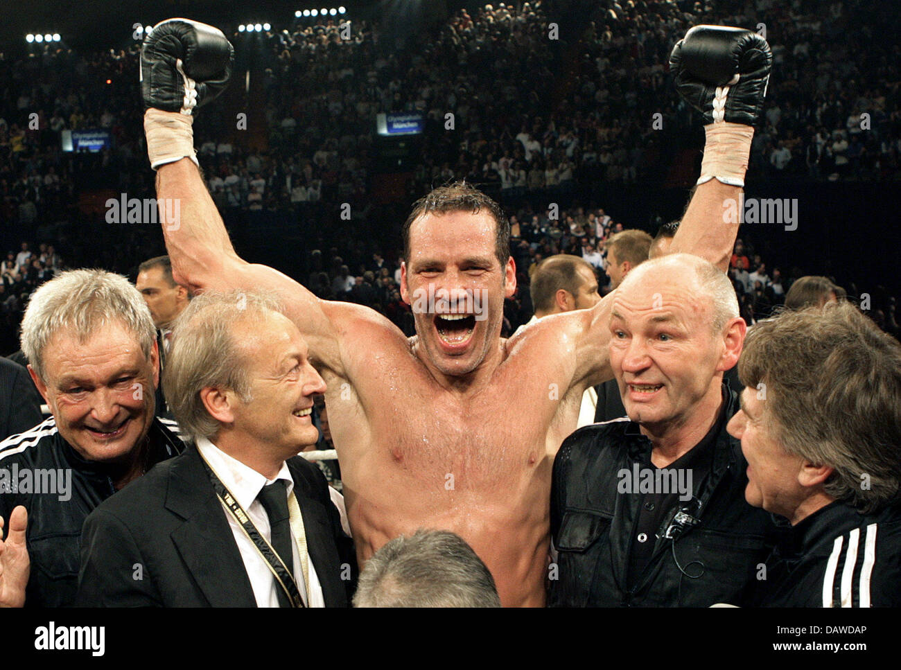 German boxer Maske his victory in the vs Hill fight next to coach Manfred Wolke (R) at the Olympic Hall in Munich, Germany, Saturday, 31 March 2007. Maske won
