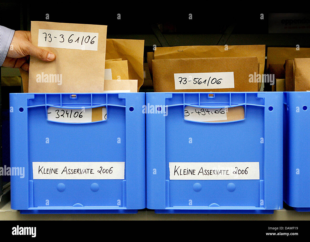 Blue plastic boxes with brown envelopes pictured in the Evidence Room