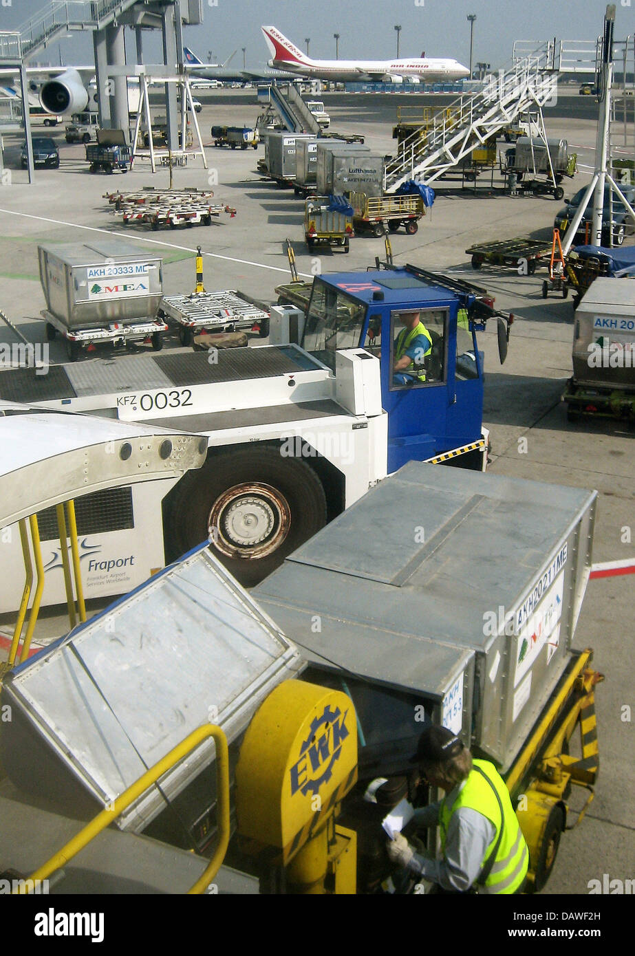 The photo shows an Air India Boeing 747 behind luggage carriers at the